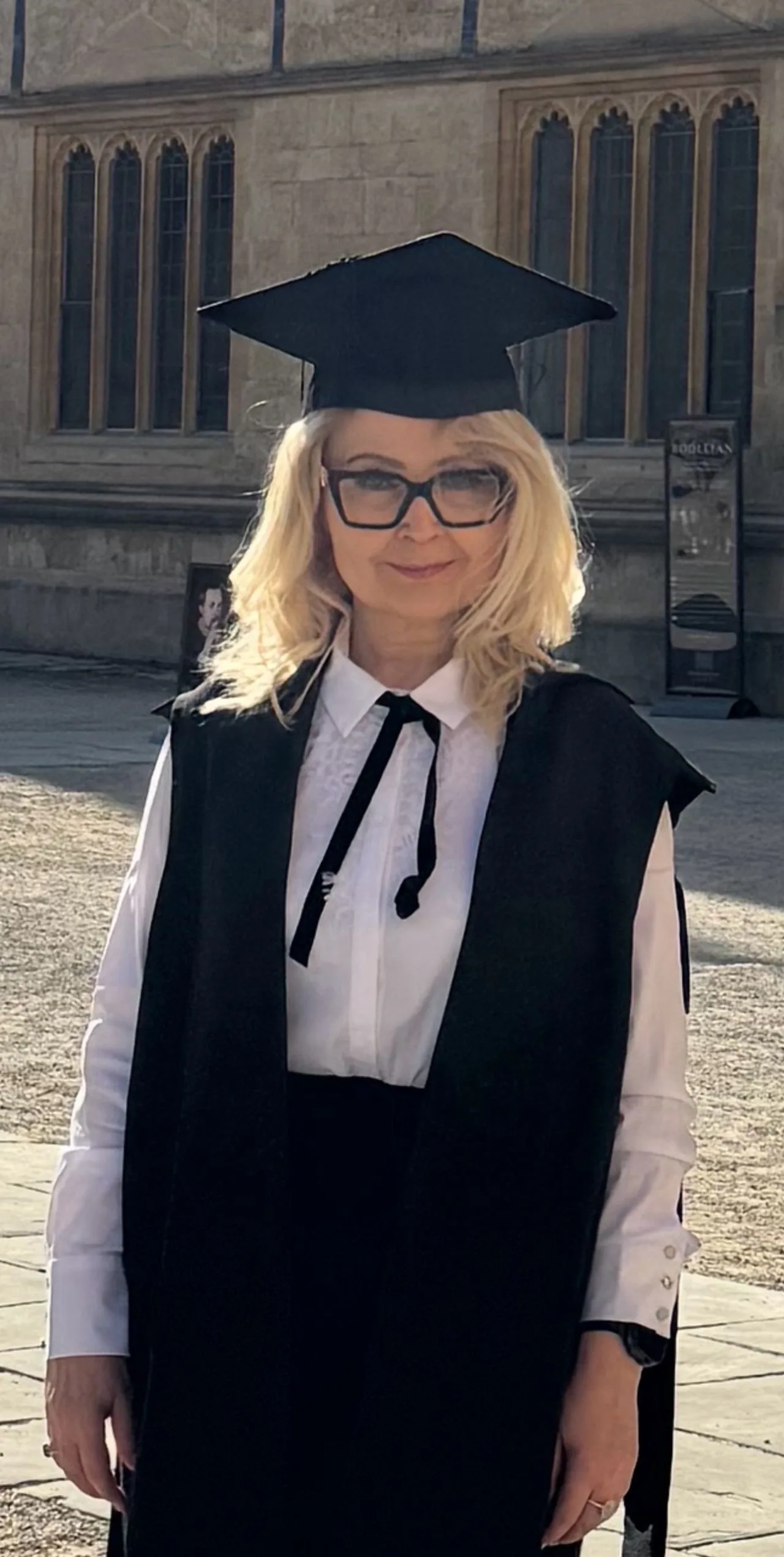 Dr Olga Mikulich in Oxford academic dress after graduating with a Diploma in Artificial Intelligence in Business